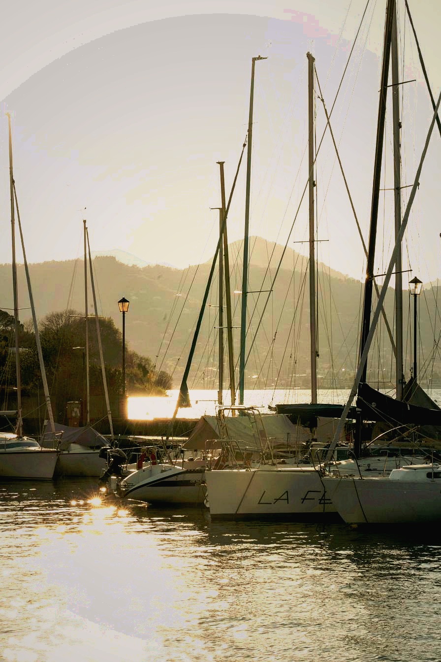 Sailing boats at Portese harbour at golden hour sunset — authentic fishermen harbour on Lake Garda near Corte Averaldo